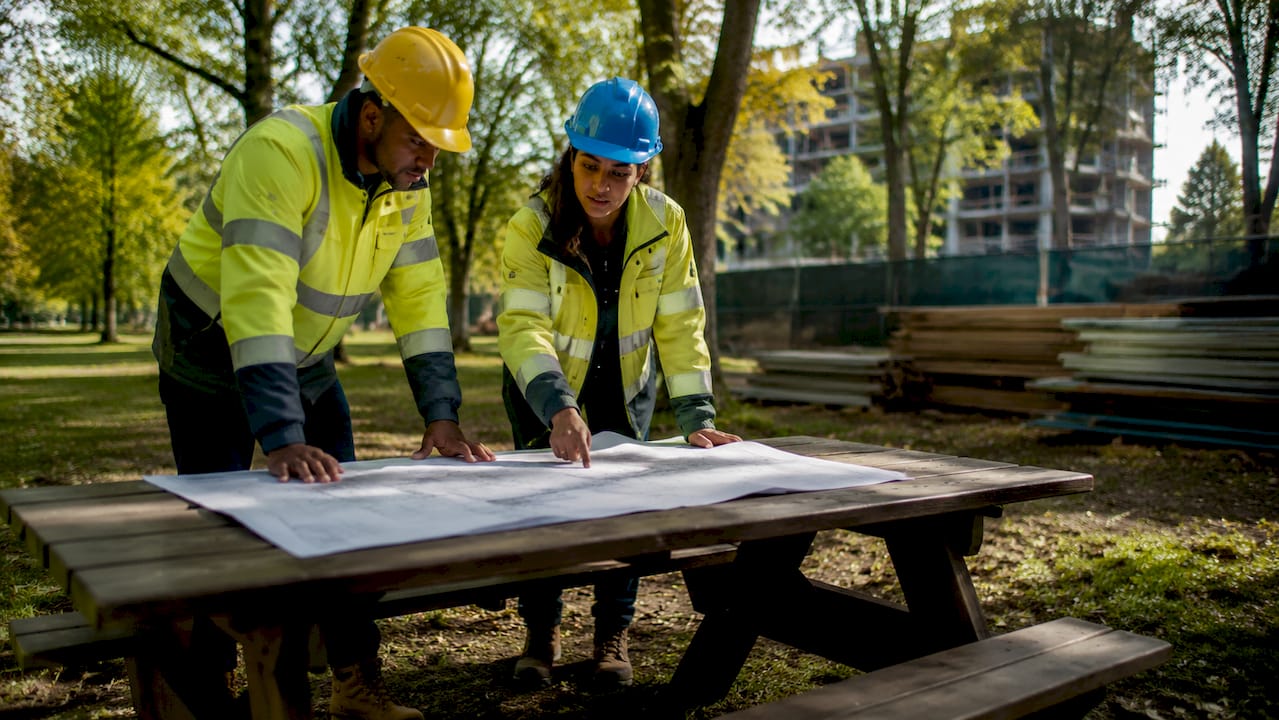 Construction managers assessing risks onsite