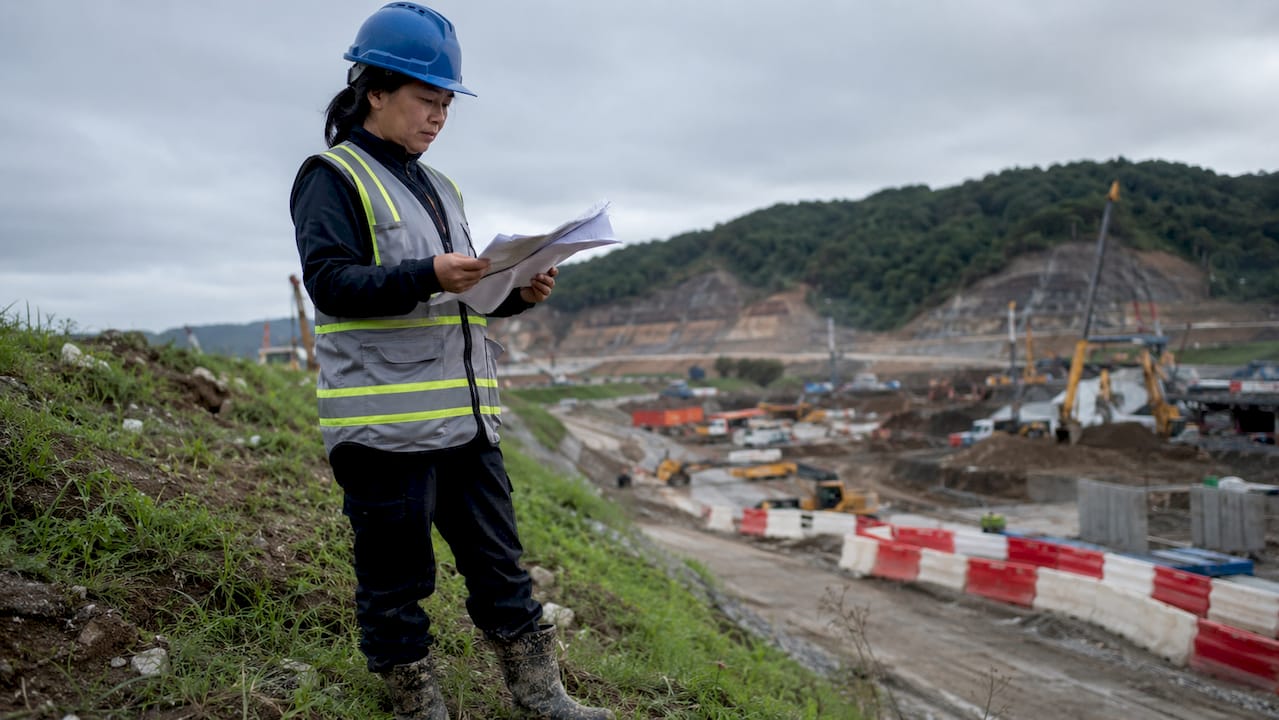 Inspector reviewing environmental reports on construction site