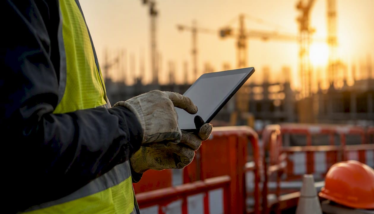 Safety officer with tablet on construction site