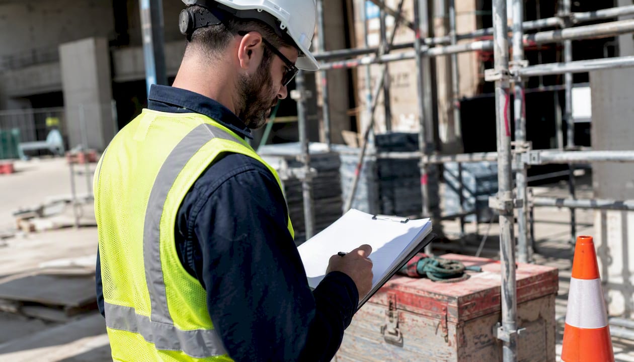 Safety officer reviewing safety documentation outdoors