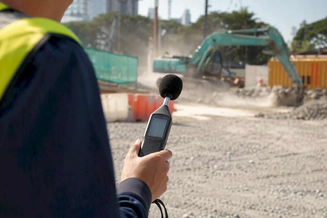 Handheld sound level meter on construction site