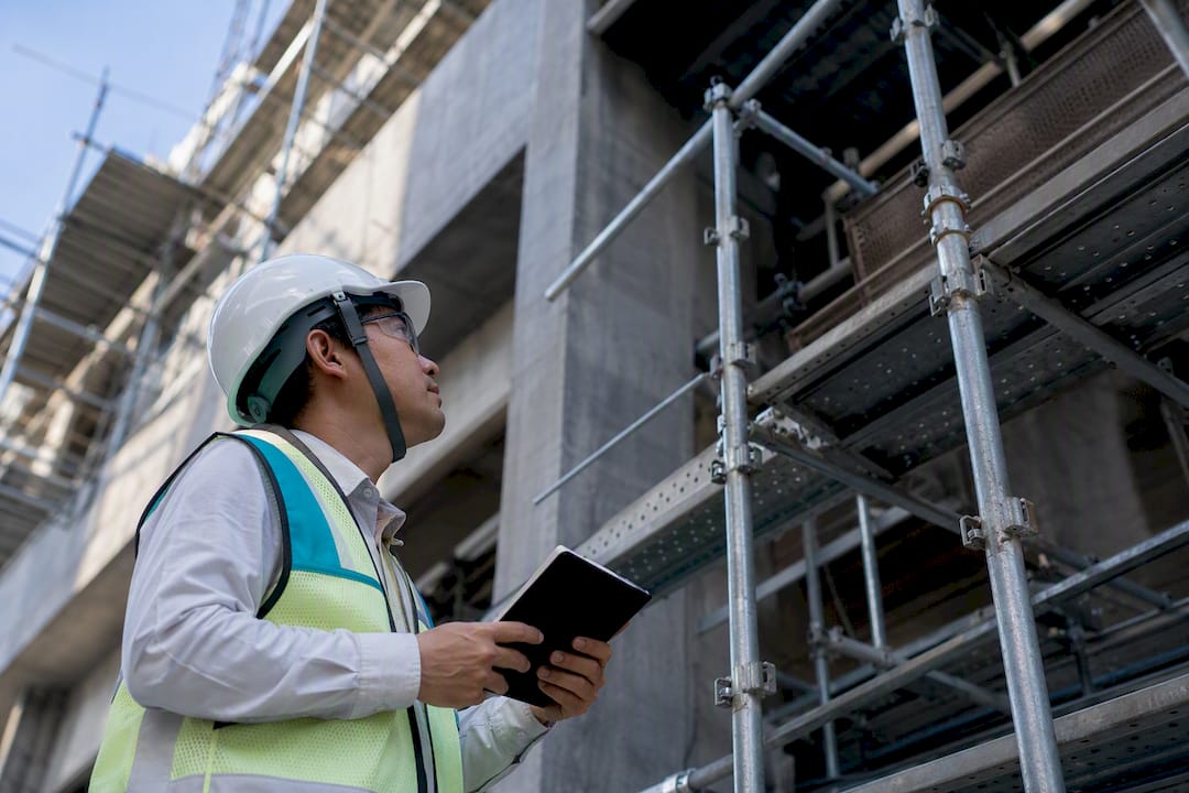 Safety auditor inspecting scaffold edge protection