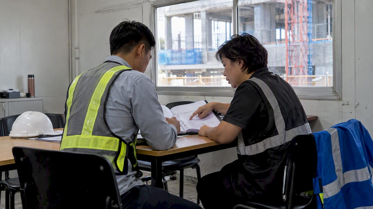 Construction team reviewing risk register for audit