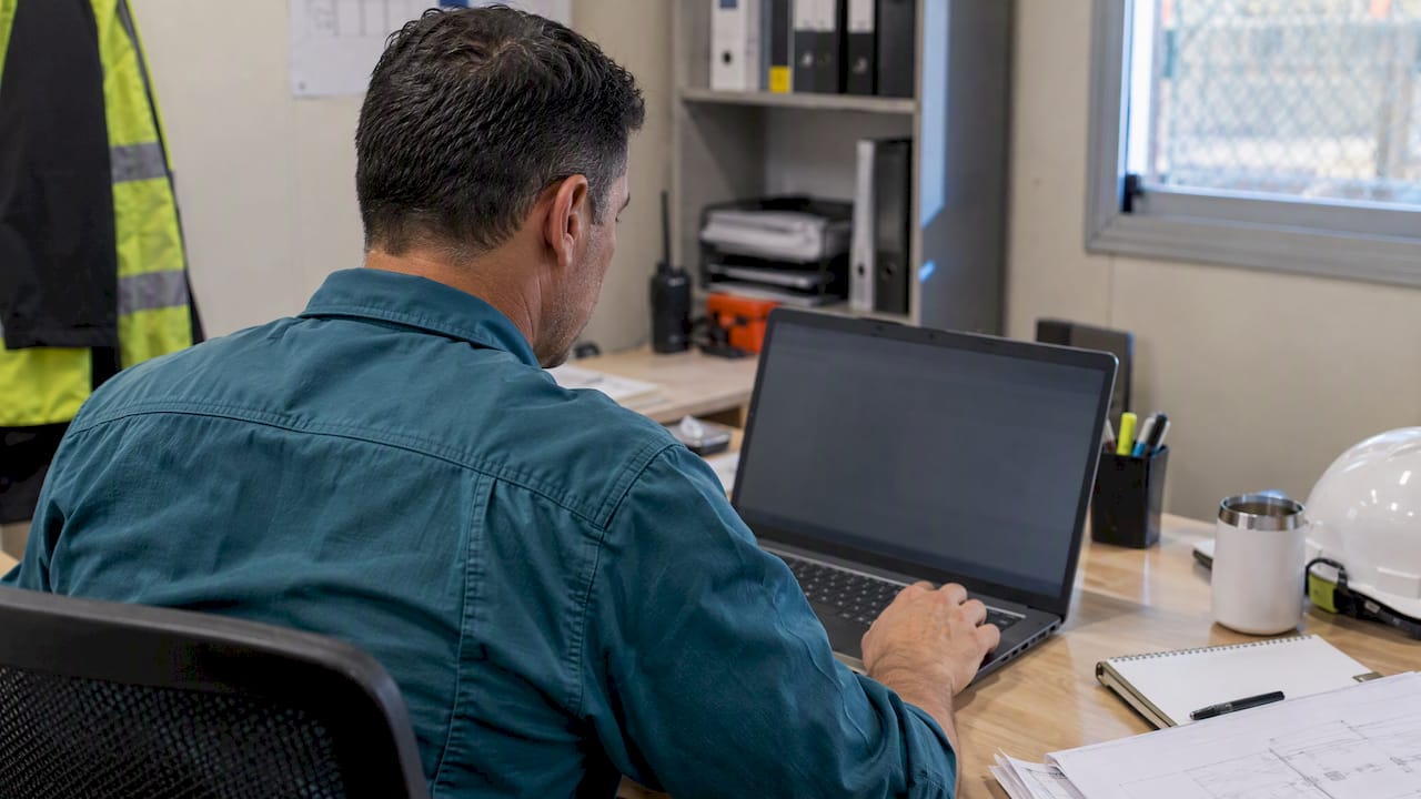 Safety officer reviewing a training matrix in Excel